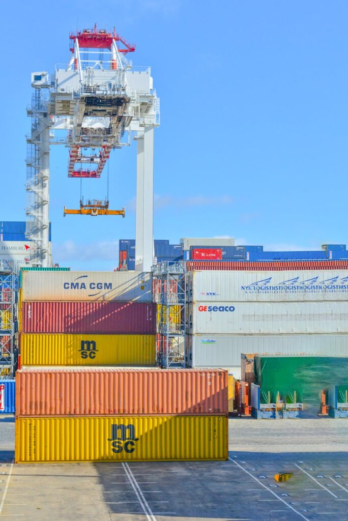 pexels-photo-2881632-2881632-1 Stacked cargo containers in a sunny port industrial setting with crane.
